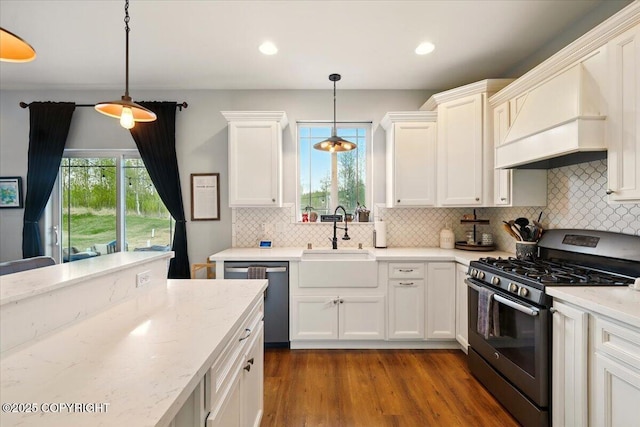 2153 S Withers Rd, Wasilla, AK 99654 - kitchen featuring stainless steel appliances, premium range hood, white cabinets, tasteful backsplash, and recessed lighting