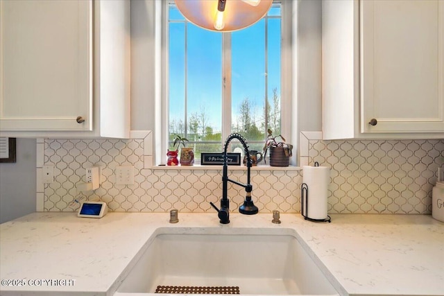 2153 S Withers Rd, Wasilla, AK 99654 - kitchen featuring white cabinetry, backsplash, and light stone counters