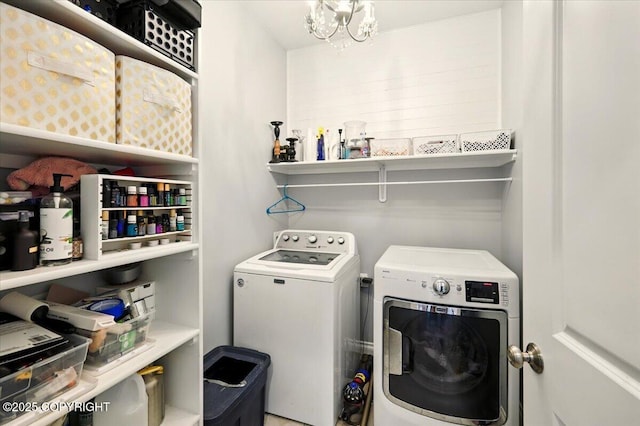 2153 S Withers Rd, Wasilla, AK 99654 - laundry room featuring washer and clothes dryer and a chandelier
