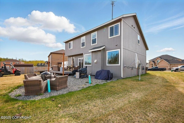 2153 S Withers Rd, Wasilla, AK 99654 - back of property with a lawn and an outdoor fire pit