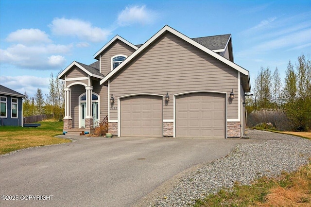 2153 S Withers Rd, Wasilla, AK 99654 - view of front facade featuring stone siding, a garage, asphalt driveway, a front lawn, and a shingled roof