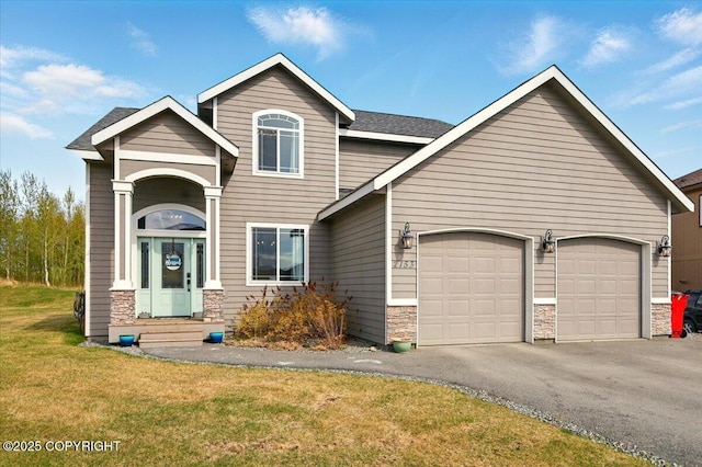 2153 S Withers Rd, Wasilla, AK 99654 - view of front of house with stone siding, an attached garage, driveway, and a front lawn