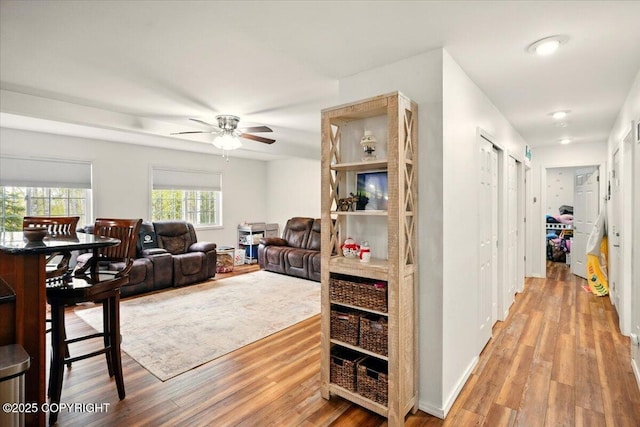 living room with wood finished floors and ceiling fan