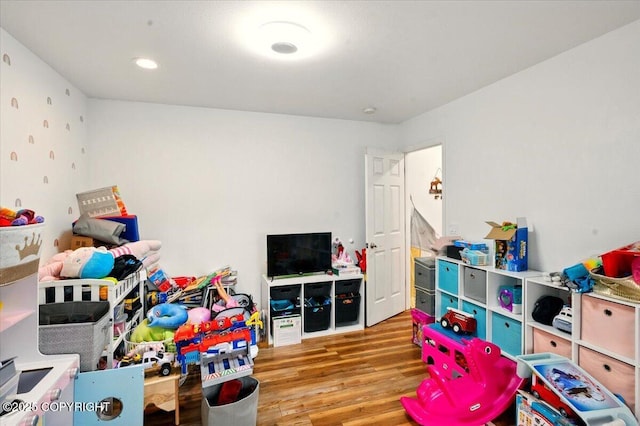 game room with wood finished floors and recessed lighting