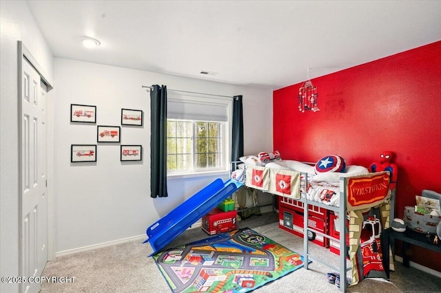 bedroom with carpet flooring, baseboards, and a closet
