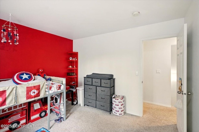 carpeted bedroom featuring baseboards