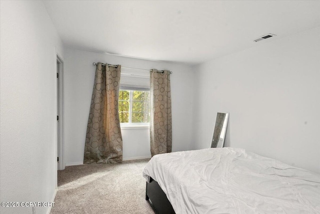 bedroom featuring carpet floors and baseboards