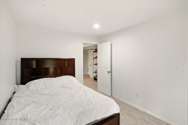 bedroom with light colored carpet, baseboards, and recessed lighting