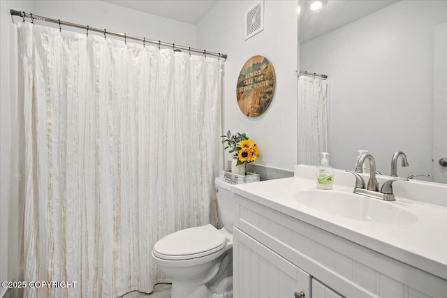 bathroom featuring toilet and vanity