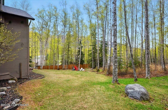 view of yard with a view of trees