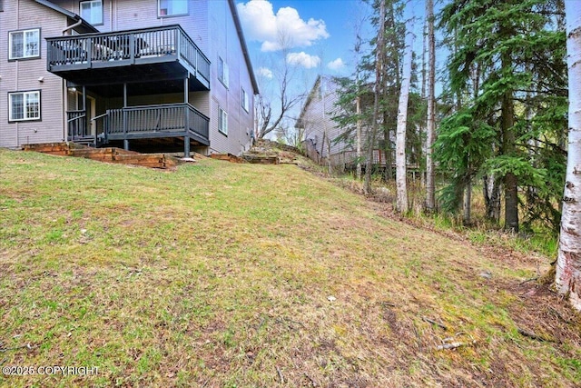 view of green lawn with a wooden deck