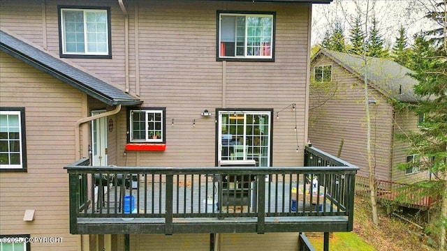 rear view of property featuring a deck