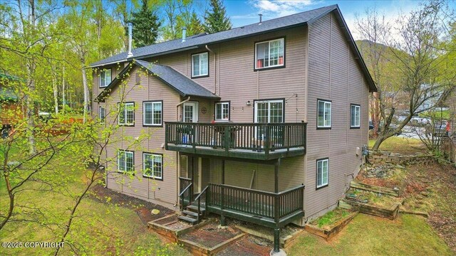 back of property with a wooden deck