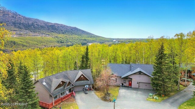 view of subject property with a forest and mountains