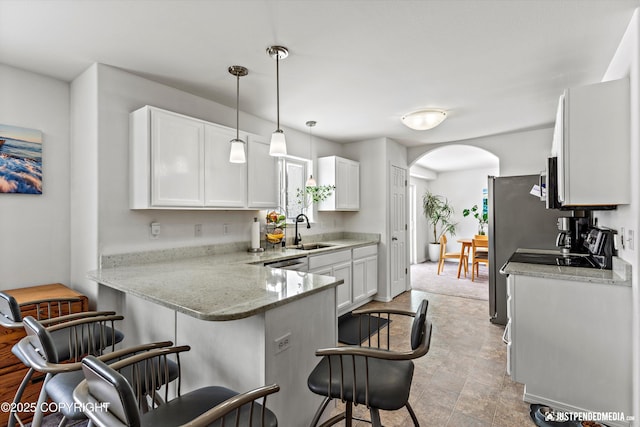 1734 Concord Hill Dr, Anchorage, AK 99515 - kitchen featuring a breakfast bar area, white cabinets, arched walkways, and a sink