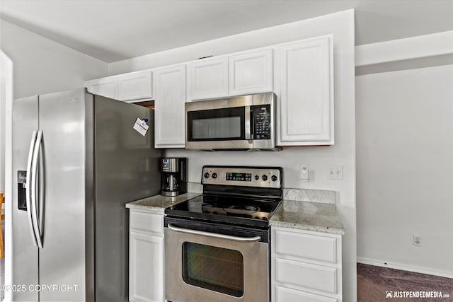 1734 Concord Hill Dr, Anchorage, AK 99515 - kitchen with light stone countertops, dark carpet, baseboards, white cabinets, and appliances with stainless steel finishes