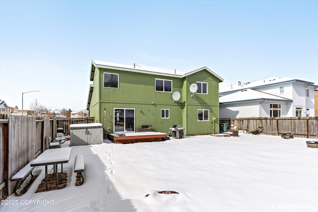 1734 Concord Hill Dr, Anchorage, AK 99515 - snow covered back of property featuring a deck and a fenced backyard
