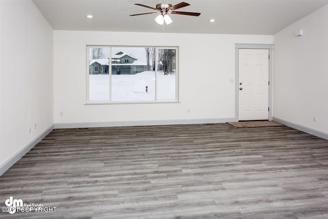 empty room with a ceiling fan, wood finished floors, baseboards, and recessed lighting