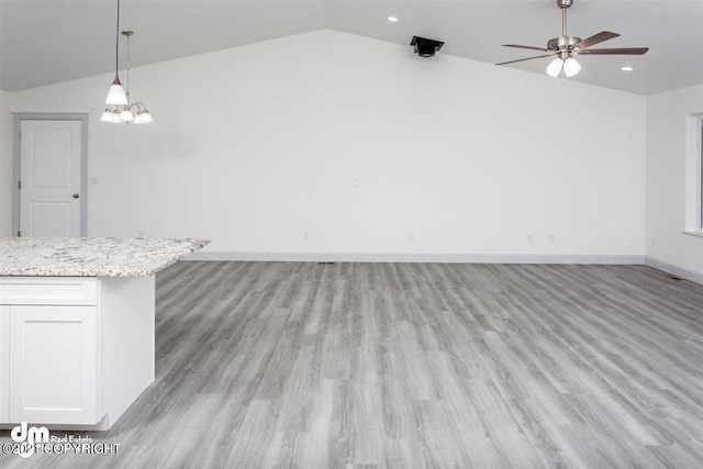 unfurnished dining area with vaulted ceiling, a ceiling fan, light wood-style floors, baseboards, and recessed lighting