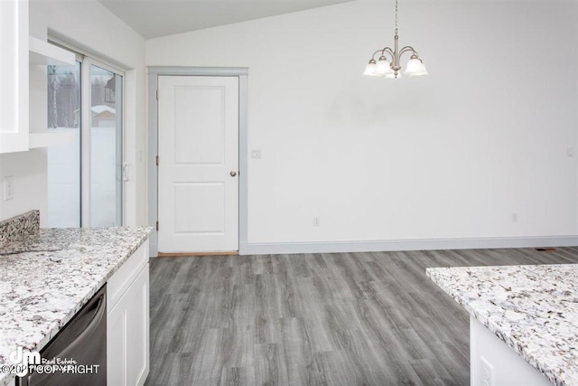 unfurnished dining area with a chandelier, light wood-type flooring, vaulted ceiling, and baseboards