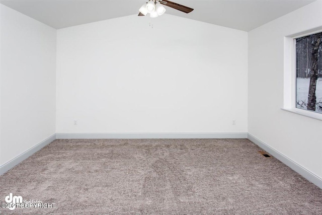 spare room with carpet flooring, a ceiling fan, and baseboards