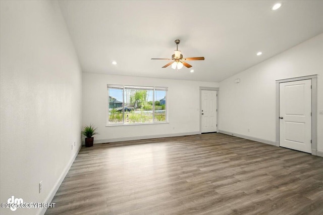 unfurnished living room with recessed lighting, a ceiling fan, wood finished floors, baseboards, and lofted ceiling