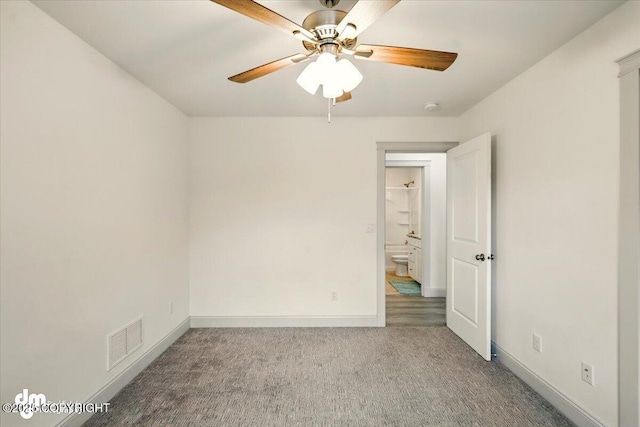 carpeted spare room featuring a ceiling fan, baseboards, and a smoke detector
