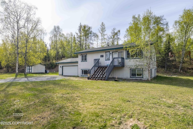 view of front of property with a front yard, a garage, and an outdoor structure