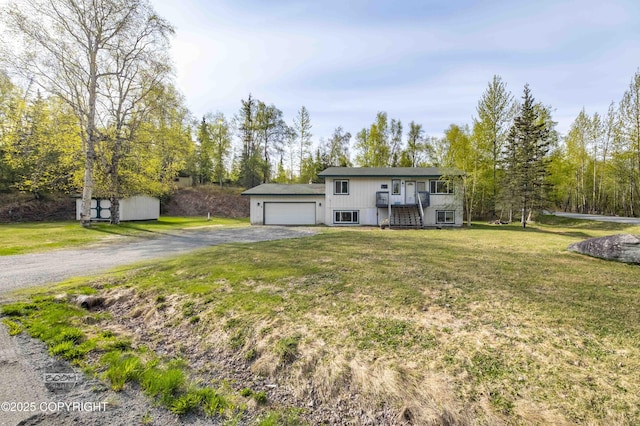 bi-level home with driveway, a front lawn, and a garage