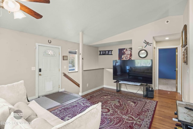living area featuring vaulted ceiling, wood finished floors, a ceiling fan, and baseboards