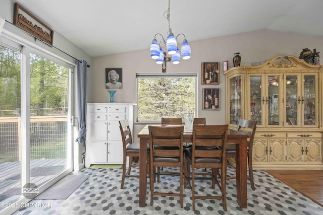 dining room featuring lofted ceiling, a chandelier, and plenty of natural light