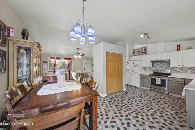 dining area featuring a chandelier, a ceiling fan, and baseboards