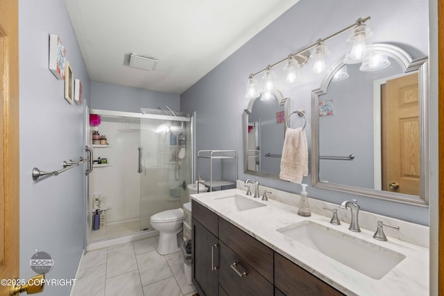 full bath with toilet, a stall shower, and double vanity