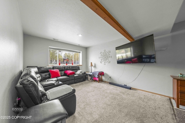 carpeted living room with baseboards and beamed ceiling