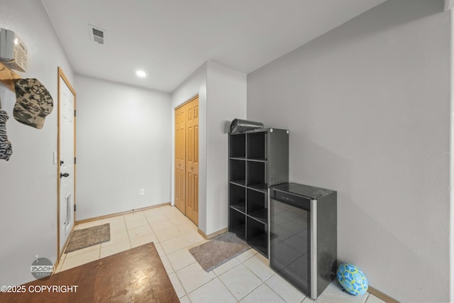 interior space featuring baseboards, recessed lighting, and light tile patterned flooring