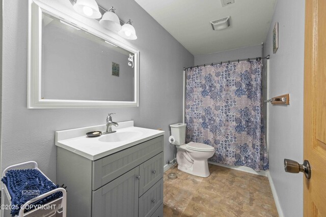 bathroom featuring vanity, toilet, baseboards, and a shower with shower curtain