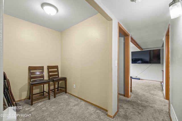 hall with carpet flooring and baseboards