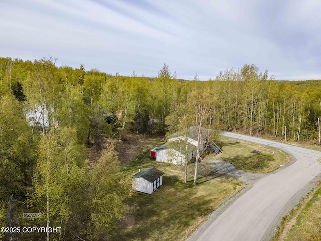 view from above of property featuring a heavily wooded area