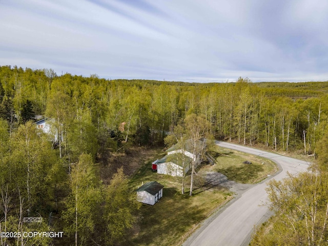 aerial view of property and surrounding area with a forest