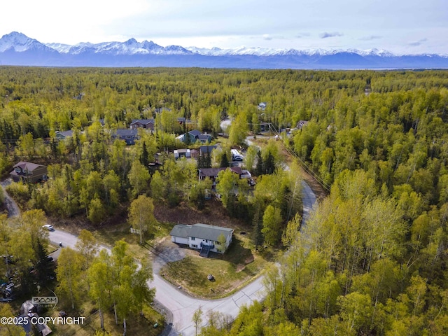 aerial view of a heavily wooded area and mountains