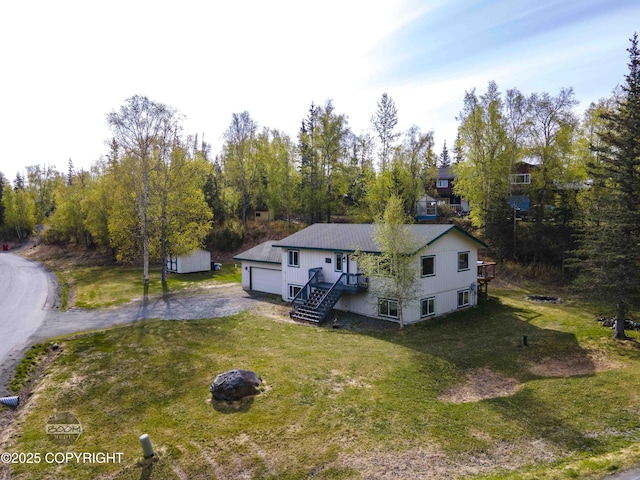 view of front of home with a front yard and a garage
