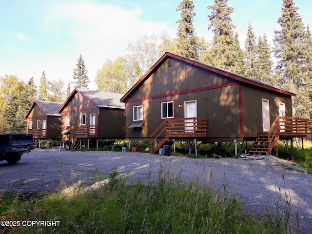 exterior space featuring a wooden deck and stairs