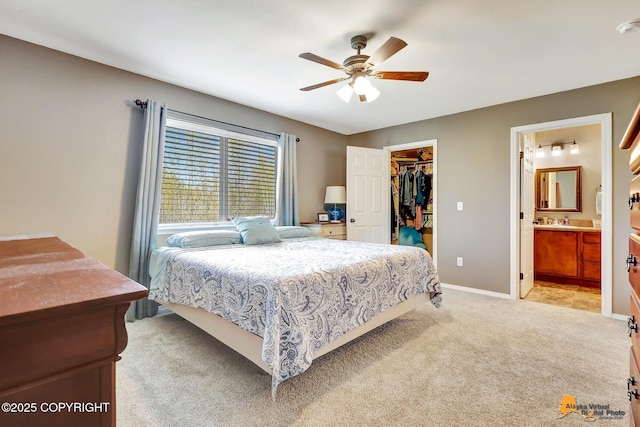 3690 S Granite Ln, Wasilla, AK 99654 - bedroom with light carpet, a walk in closet, a closet, baseboards, and ceiling fan