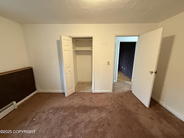 unfurnished bedroom featuring a closet, carpet flooring, baseboards, and a baseboard radiator