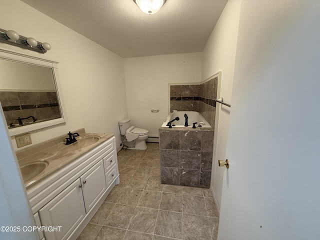 bathroom with a garden tub, double vanity, tile patterned flooring, toilet, and a sink