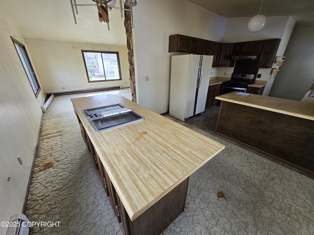 kitchen with freestanding refrigerator, carpet, stainless steel gas stove, and dark brown cabinetry