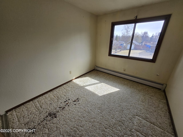 carpeted empty room with baseboards and a baseboard radiator