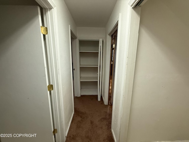 corridor featuring dark colored carpet