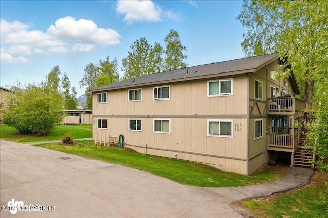 2631 Palmer Ct # C6, Anchorage, AK 99508 - back of property featuring stairway, a yard, and a wooden deck
