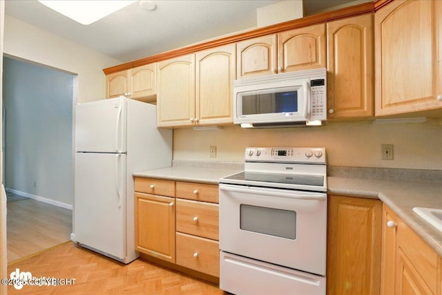 2631 Palmer Ct # C6, Anchorage, AK 99508 - kitchen featuring white appliances, light brown cabinetry, light countertops, and parquet floors